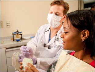 Dentist discussing teeth whitening with student